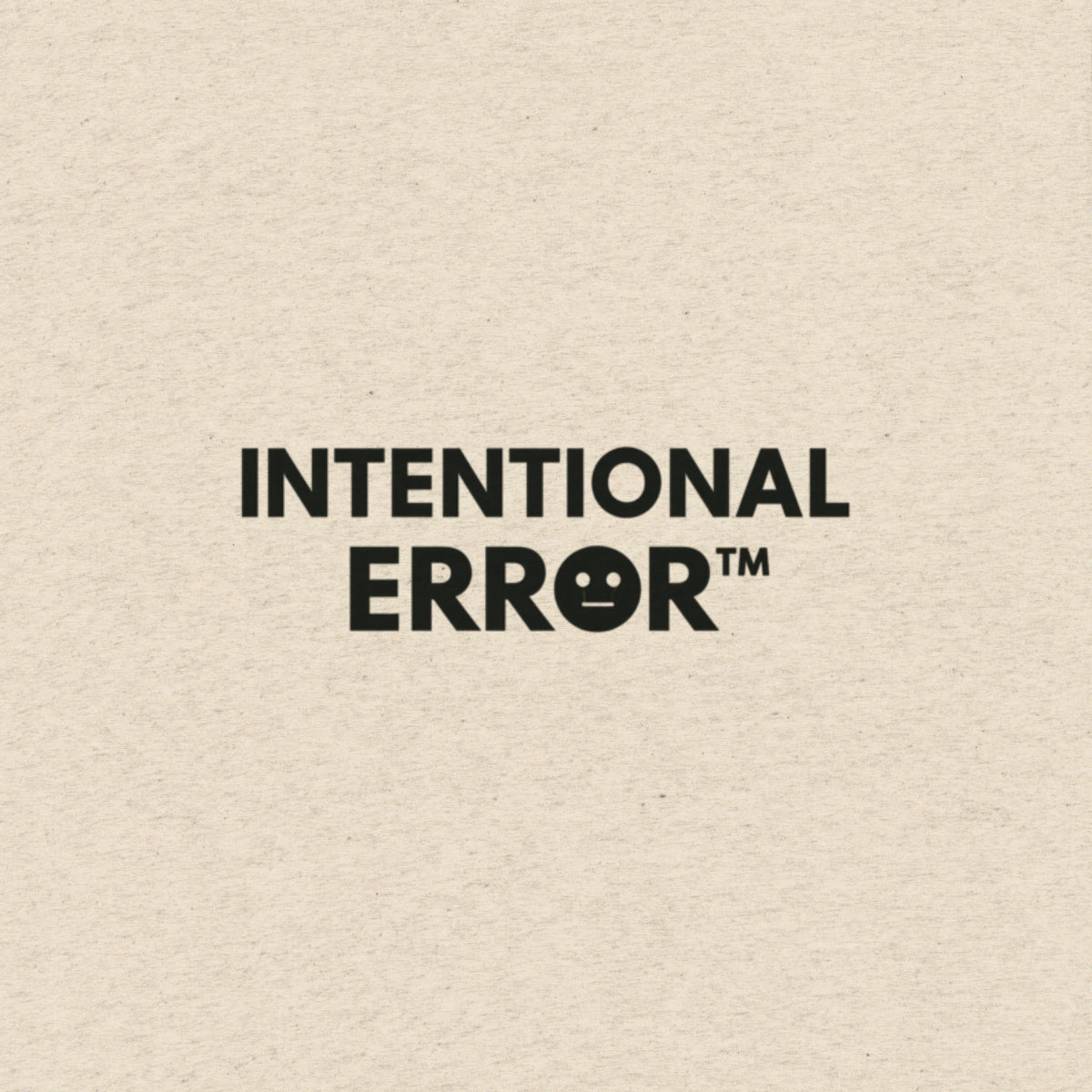 Text 'INTENTIONAL ERROR™' on a soft beige t-shirt background