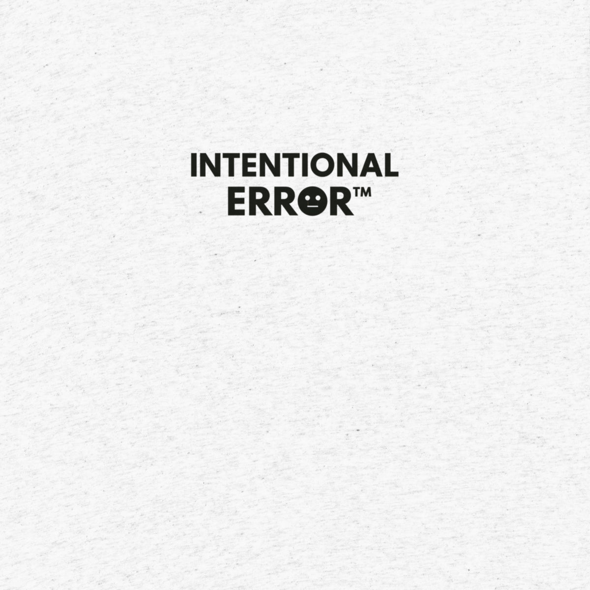 Back of shirt featuring small “Intentional Error” logo centered across the shoulders, minimalist design.