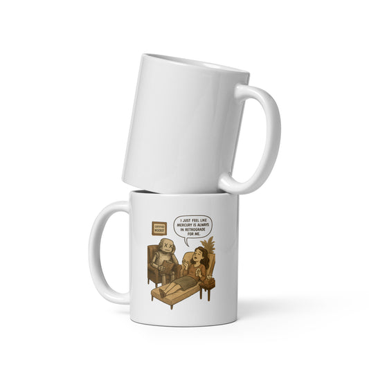 A white ceramic mug with woman in therapy saying “It just feels like Mercury is always in retrograde for me” to a sad-looking robot therapist.
